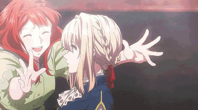 a girl with red hair is giving a peace sign next to another girl