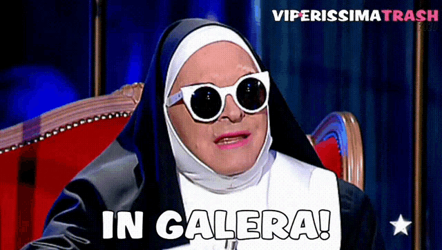 a nun is sitting in a chair with the words in galera behind her