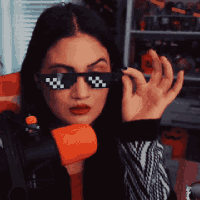 a woman wearing sunglasses with a checkered pattern