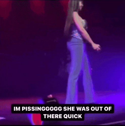 a woman is dancing on a stage with purple lights behind her and a caption that says im pissingggg she was out of there quick