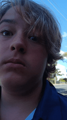 a close up of a person 's face with a blue background