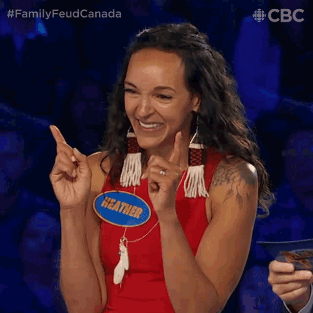 a woman with the name heather on her shirt is smiling