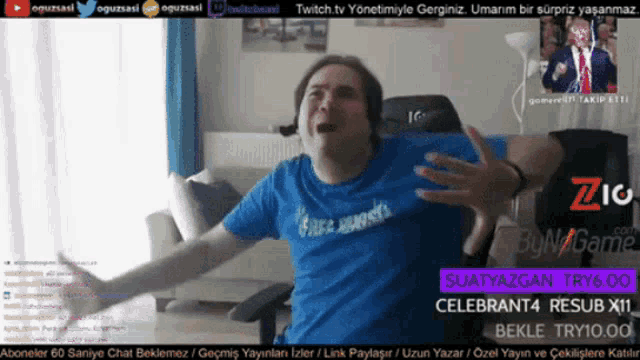 a man in a blue shirt is sitting in a chair with his arms outstretched