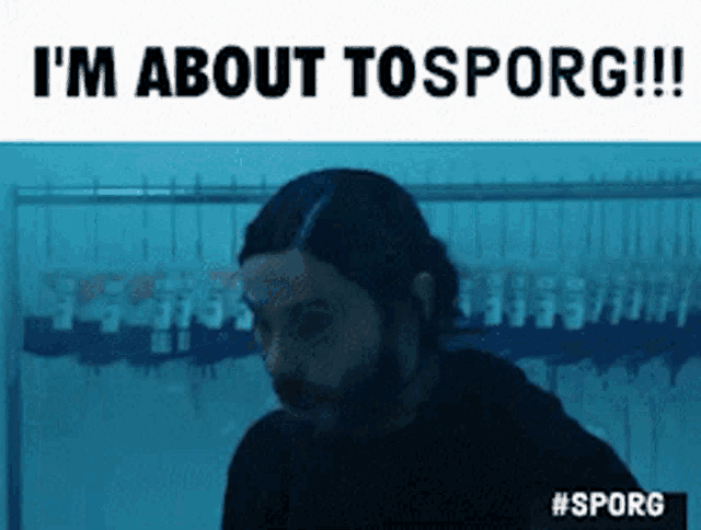 a man with a beard is standing in front of a hanger with the words i 'm about tosporg !!!