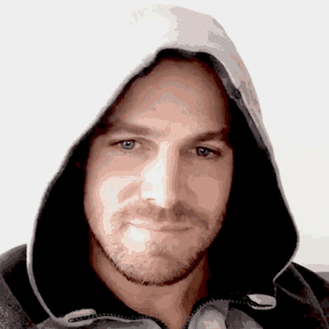 a man with a beard is wearing a hoodie