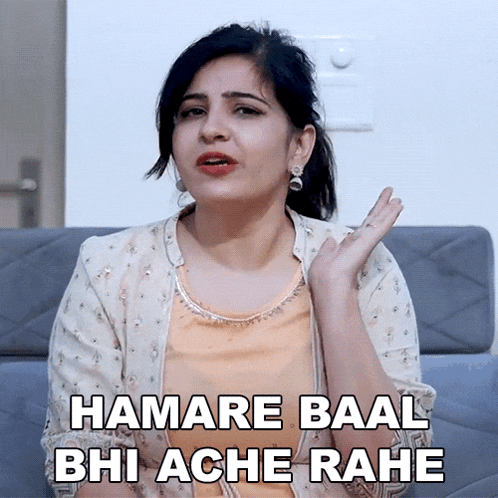 a woman sitting on a couch with the words hamare baal bhi ache rahe written below her