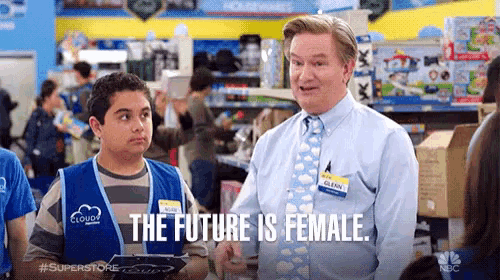 a man and a boy are standing in a store and the man is saying the future is female .
