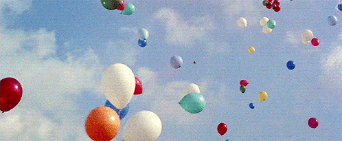 a bunch of balloons are floating in the sky