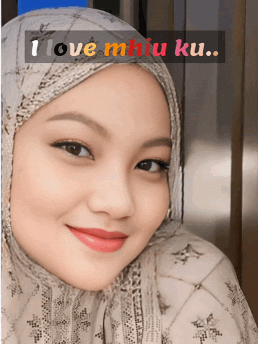 a woman wearing a hijab with the words i love miu ku