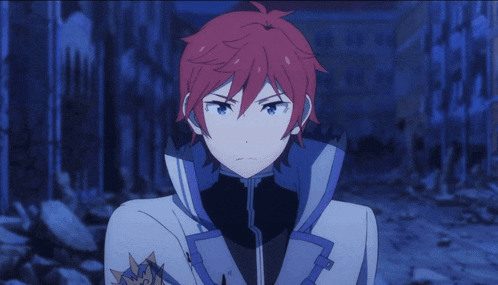 a man with red hair and blue eyes is standing in a dark room