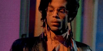 a close up of a person 's face with glasses and a purple and green background .