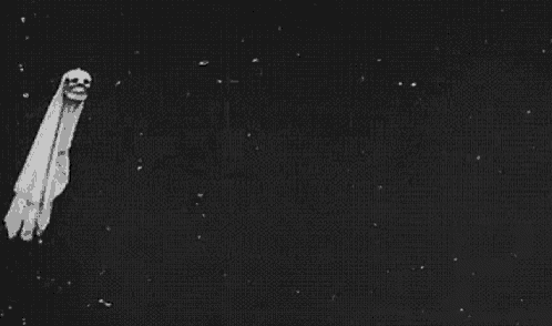 a black and white photo of a ghost with a skull on its head .