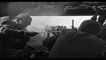 a black and white photo of two soldiers in a trench