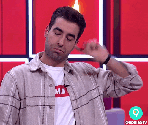 a man wearing a plaid shirt with a mb t-shirt on