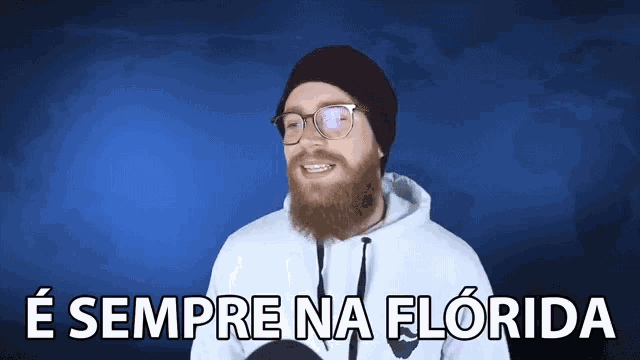 a man with a beard wearing glasses and a white hoodie with the words e sempre na florida below him