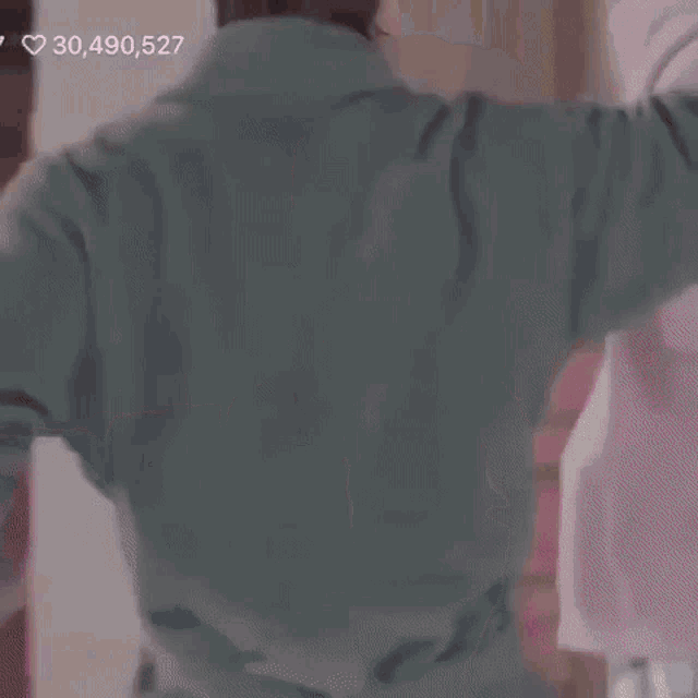 a group of people are standing in a room and one of them is wearing a robe .