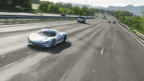 a white sports car driving down a highway with other cars
