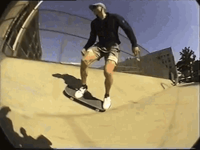 a man is riding a skateboard down a sandy ramp