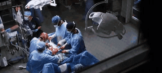 a group of surgeons performing surgery on a patient