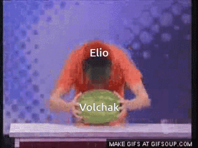 elio volchak is holding a green watermelon in his hands