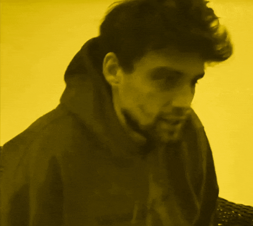 a man with a beard wearing a black jacket