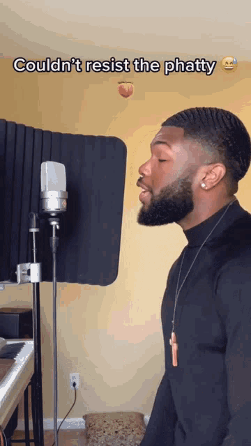 a man singing into a microphone with the words " couldn 't resist the phatty " above him