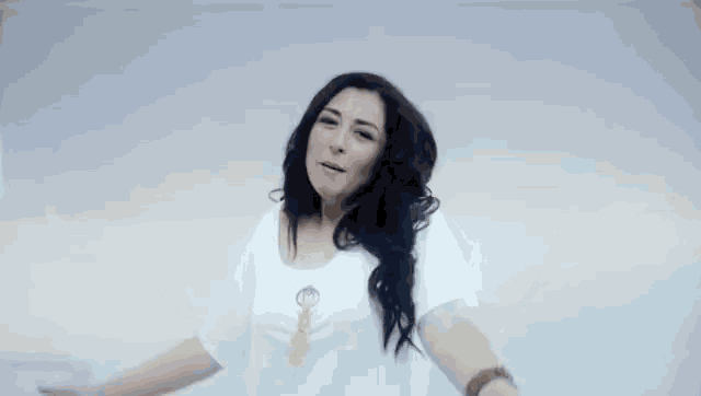 a woman in a white t-shirt with a key on the front