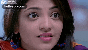 a close up of a woman 's face with a surprised expression .