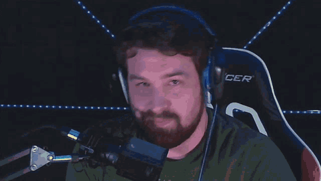 a man wearing headphones says " it 's free real estate " while sitting in front of a microphone