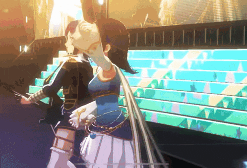 a woman in a blue dress stands on a stage