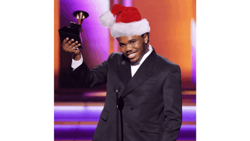 a man wearing a santa hat holds a trophy in his hand