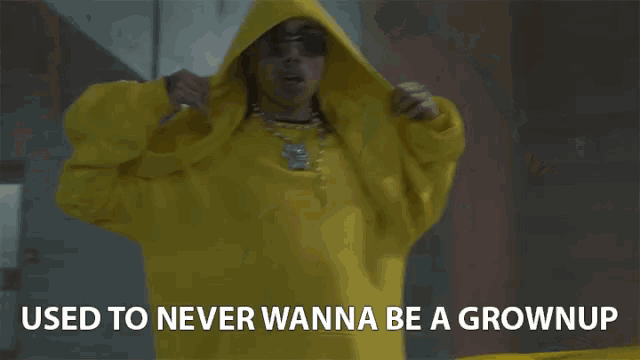 a man wearing a yellow hoodie and sunglasses says used to never wanna be a grownup