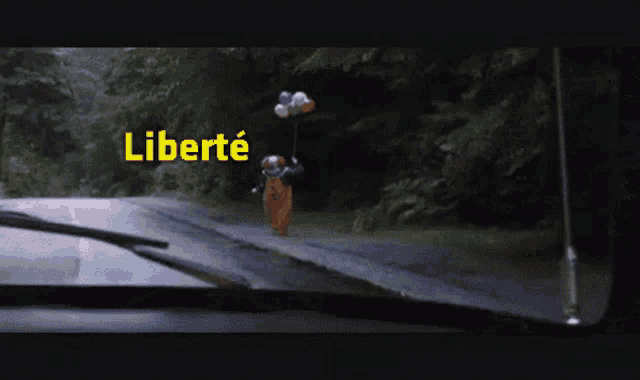 a clown is holding a conductor 's baton and the word fraternite is above him