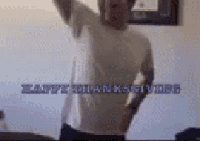 a man in a white shirt is dancing in a room with the words `` happy thanksgiving '' written in the background .