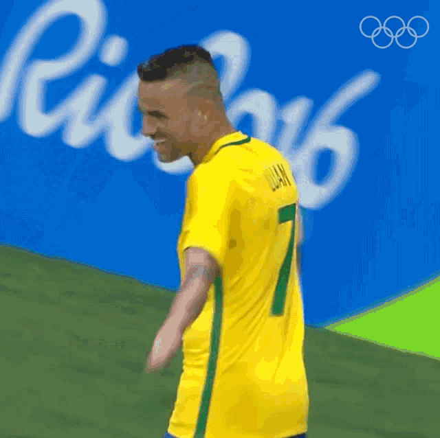 a man in a yellow shirt with the number 7 on the back
