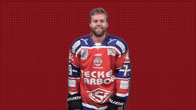 a man is wearing a red and blue jersey that says becker carbon on it .