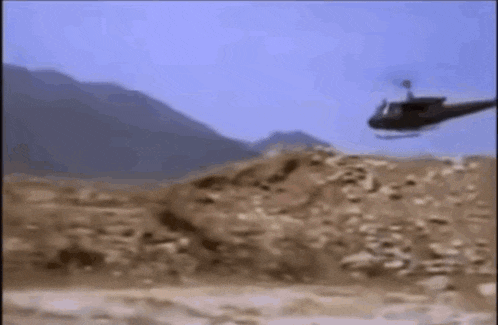 a helicopter is flying over a desert landscape