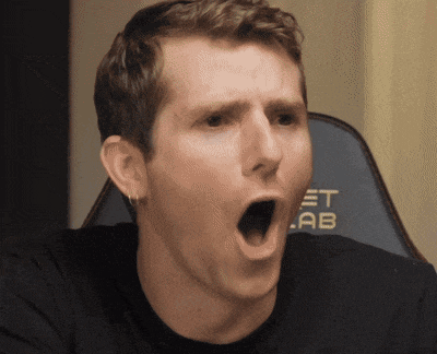 a man with his mouth open is sitting in front of a chair that says et lab