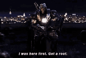 a man in a superhero costume says i was here first get a roof