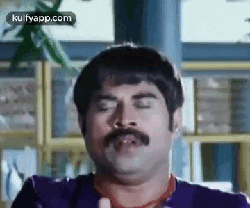 a man with a mustache is making a funny face with his eyes closed and his mouth open .