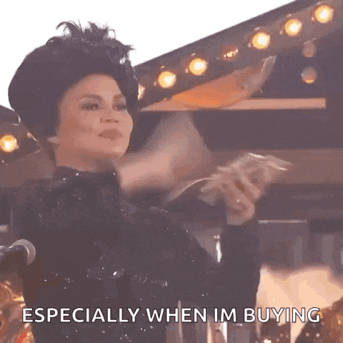 a woman in a black dress is holding a bunch of money and says especially when i 'm buying .