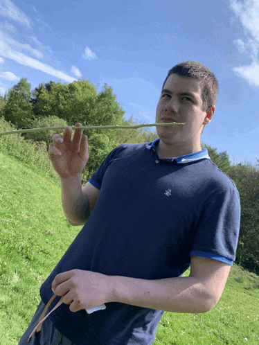 a man in a blue shirt with a bee on it