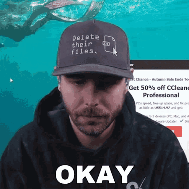 a man wearing a hat that says delete their files is okay