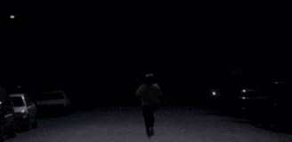 a row of cars are parked in the dark