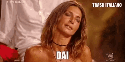 a woman is making a funny face with her eyes closed and the word dai on her chest .