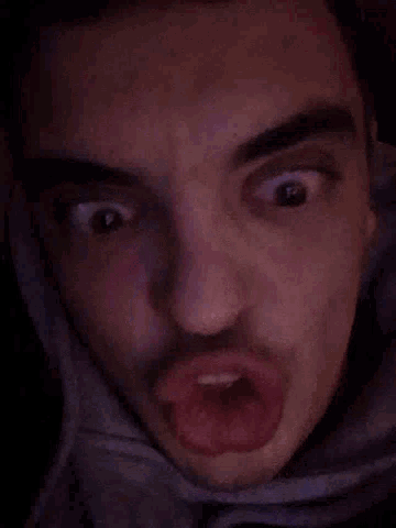 a close up of a person 's face with a dark background