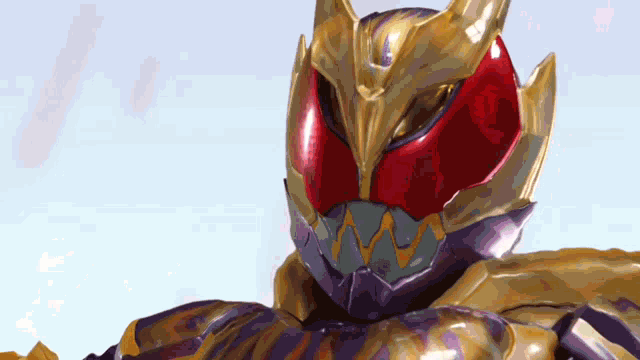 a close up of a red and gold helmet