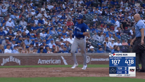 a blue jays baseball player is running towards home plate during a game
