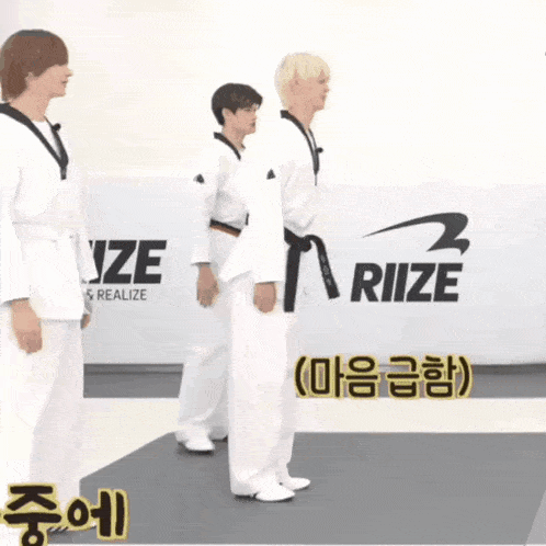 three karate fighters are standing in front of a wall that says riize