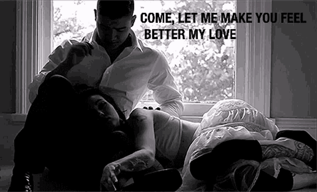 a man and a woman are laying on the floor in front of a window with the words come let me make you feel better my love .